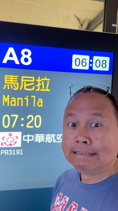 Selfie at Taipei airport gate A8 with the board showing the Manila flight