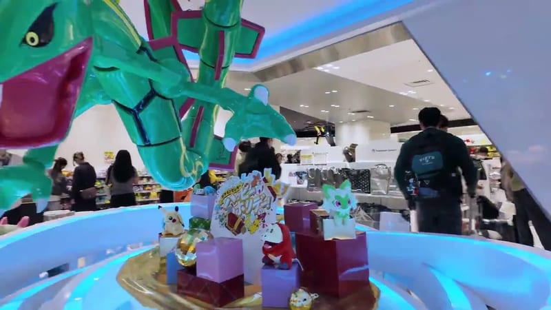 Large Pokémon display featuring a green dragon-type Pokémon and figures inside a store at Tokyo Skytree Town, Tokyo, Japan