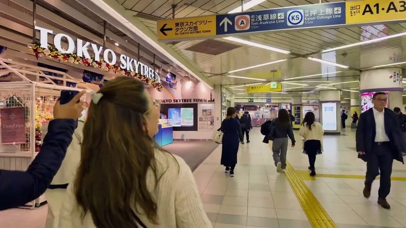 Busy Tokyo subway station concourse with signs for Tokyo Skytree Town and multiple subway lines, Tokyo, Japan