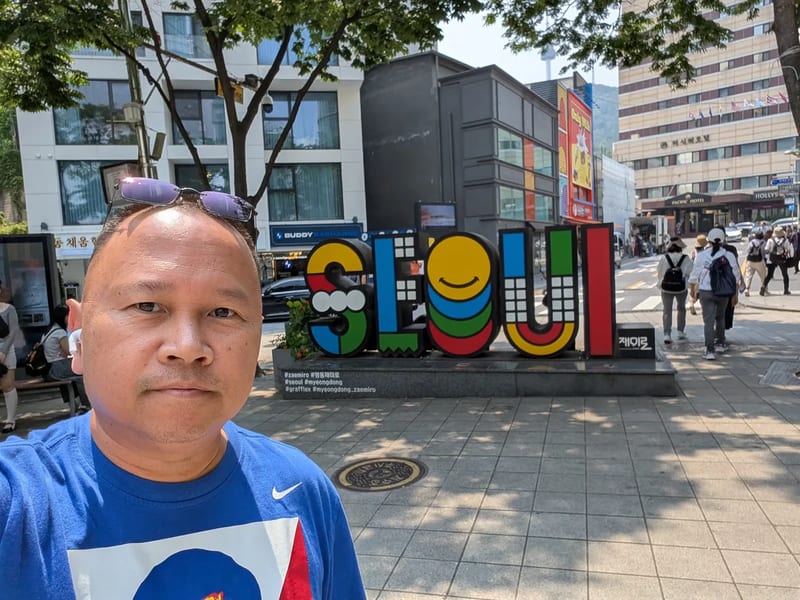 Selfie in front of the colorful SEOUL letters sign in Myeongdong