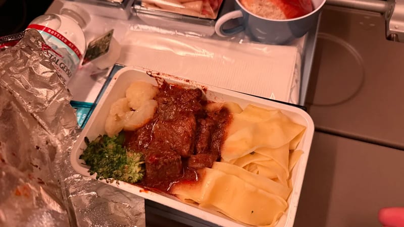 China Airlines meal of beef in sauce with wide noodles and broccoli
