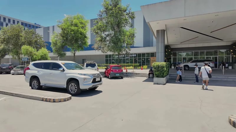 Arriving in the Manila heat with vans and SUVs at the curb