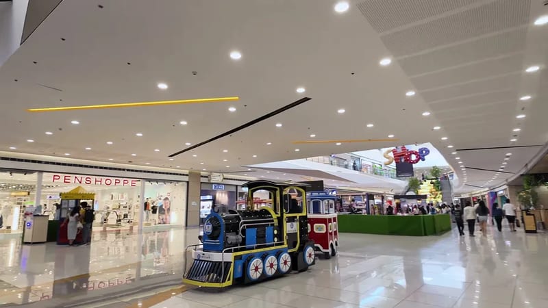 Inside an SM mall with a kiddie train ride passing a Penshoppe store