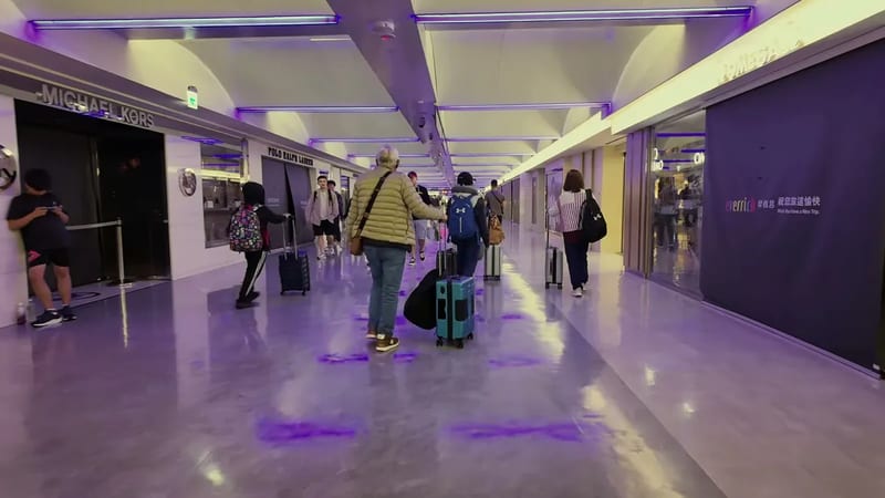 Purple-lit corridor with vending machines at Taipei Taoyuan airport