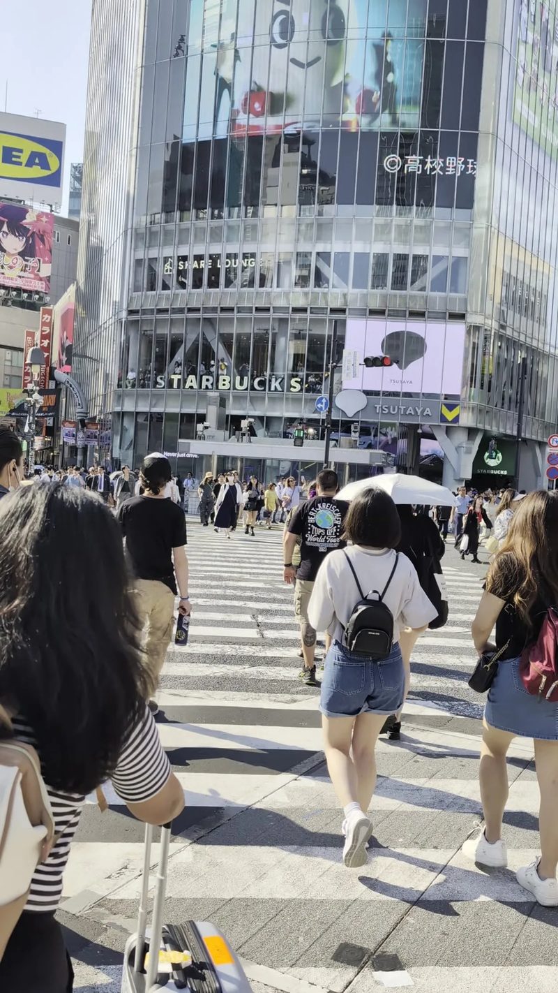 Bustling Shibuya Crossing in Tokyo, Japan, with pedestrians and the Shibuya 109 building in the background.