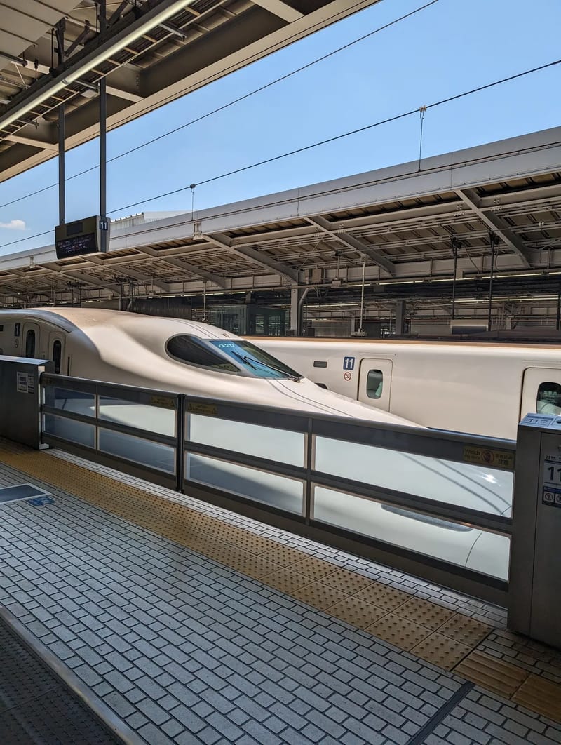 Aerodynamic nose of a Shinkansen bullet train at Shin-Osaka Station platform, Japan.