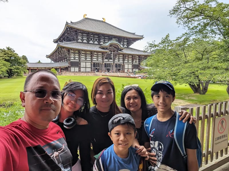 Family selfie in front of Todai-ji Temple's Great Buddha Hall in Nara, Japan.