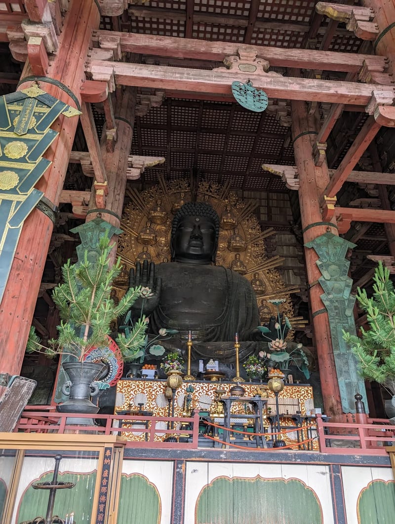Close-up of the large bronze Buddha statue inside Todai-ji Temple's Daibutsuden in Nara, Japan.
