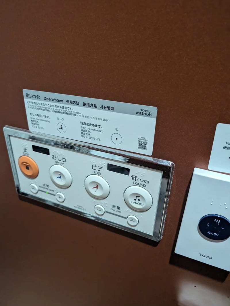 Toto Washlet toilet control panel with bidet and sound functions in Japan.