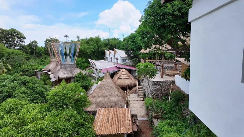 Wait, is that a pool? A couple of them, actually View from the restaurant balcony over thatched nipa huts and turquoise pools set into the hillside