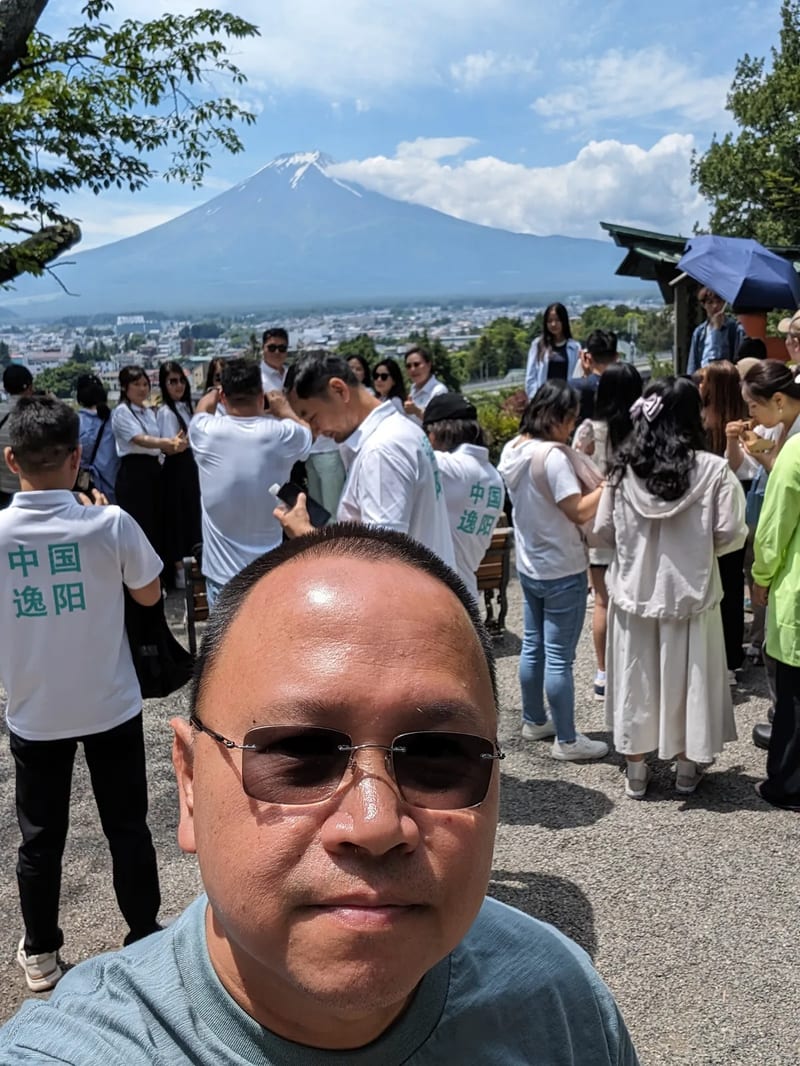 Family photo with Mount Fuji — Fujiyoshida, Yamanashi, Japan Family of four posing in front of Mount Fuji overlooking Fujiyoshida, Yamanashi, Japan.