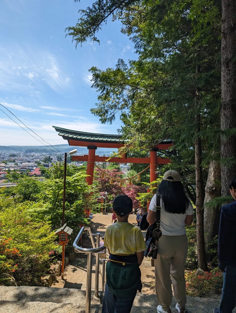 Torii gate path with stone lanterns at Arakurayama Sengen Park in Fujiyoshida, Yamanashi, Japan.