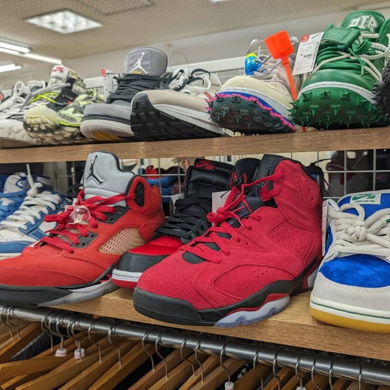 Red and black Air Jordan sneakers on a shelf at Second Street resale store in Japan.