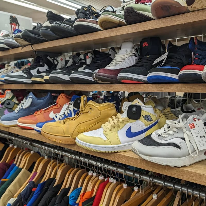 Yellow and blue Nike sneakers on a shelf at Second Street resale store in Japan.