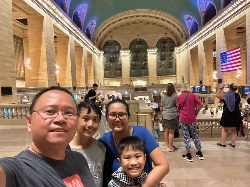 Family selfie inside Grand Central Terminal with grand architecture