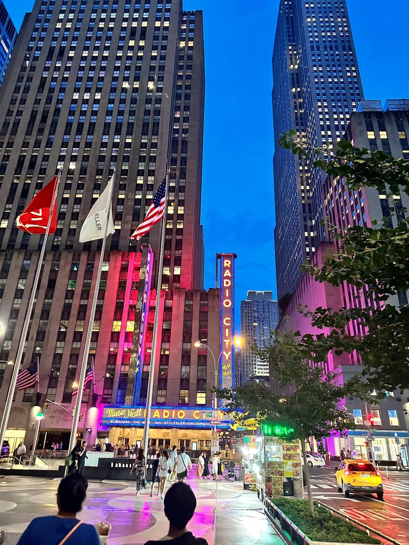 Radio City Music Hall exterior at dusk with neon lights