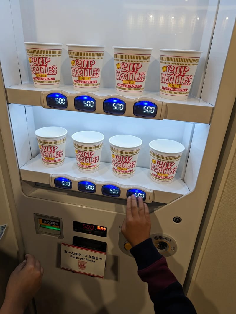Custom Cup Noodles being heat-sealed in machine at My Cup Noodles Factory, Osaka, Japan.
