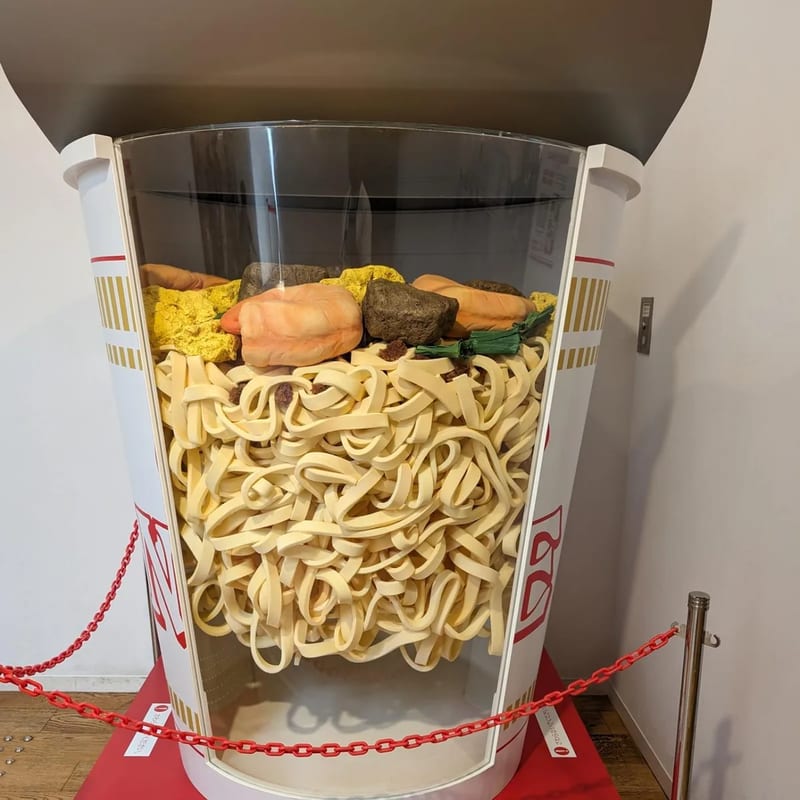 Giant cutaway Cup Noodles display showing noodle cross-section at Cup Noodles Museum in Osaka, Japan.