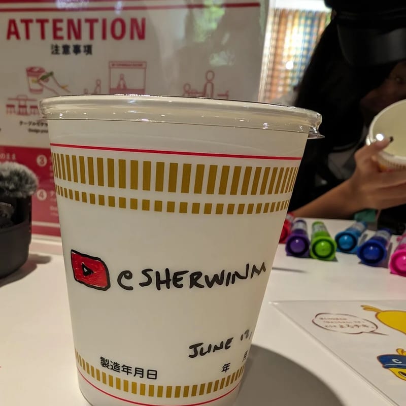 Custom Cup Noodles decorated with Sherwin's artwork at My Cup Noodles Factory, Osaka, Japan.