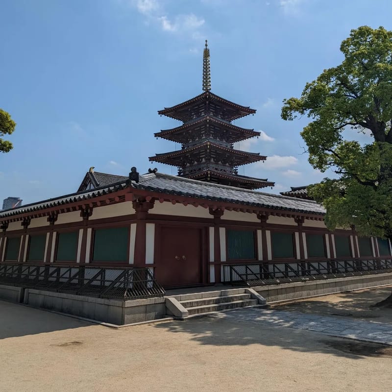 Five-story pagoda at Shitennoji Temple surrounded by trees in Osaka, Japan.