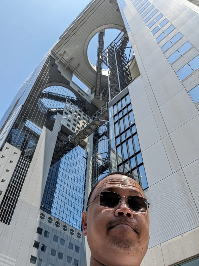 Umeda Sky Building low-angle architectural view showing towers and circular observation deck in Osaka, Japan.