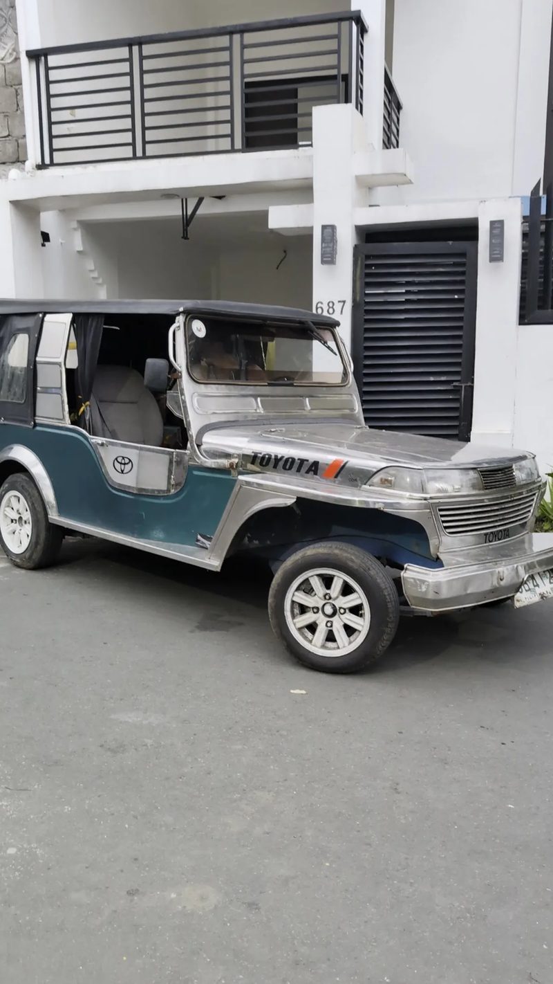 Teal and silver Toyota Owner Type Jeep parked in front of a house numbered 687 in Liliw, Laguna, Philippines.