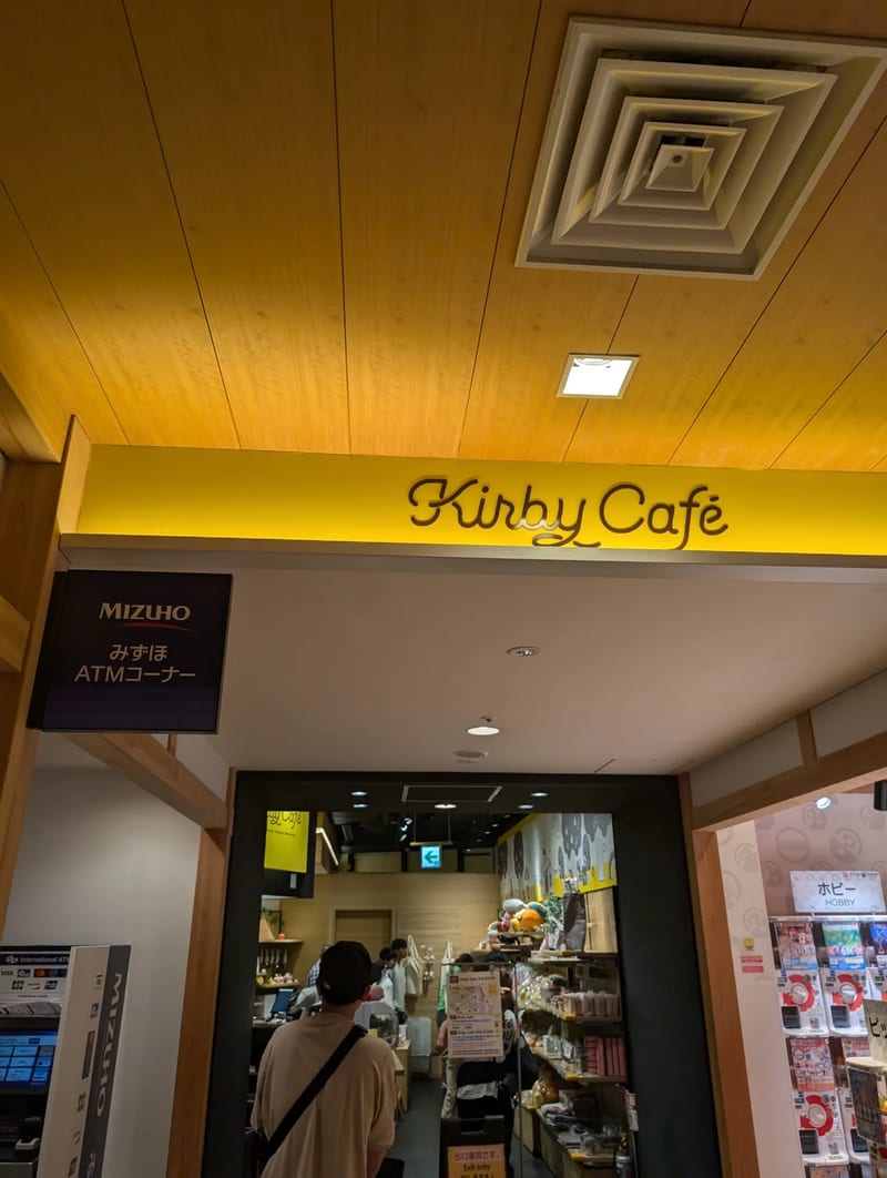 Entrance to the Kirby Cafe with a distinctive yellow sign and wooden ceiling at Solamachi, Tokyo, Japan.