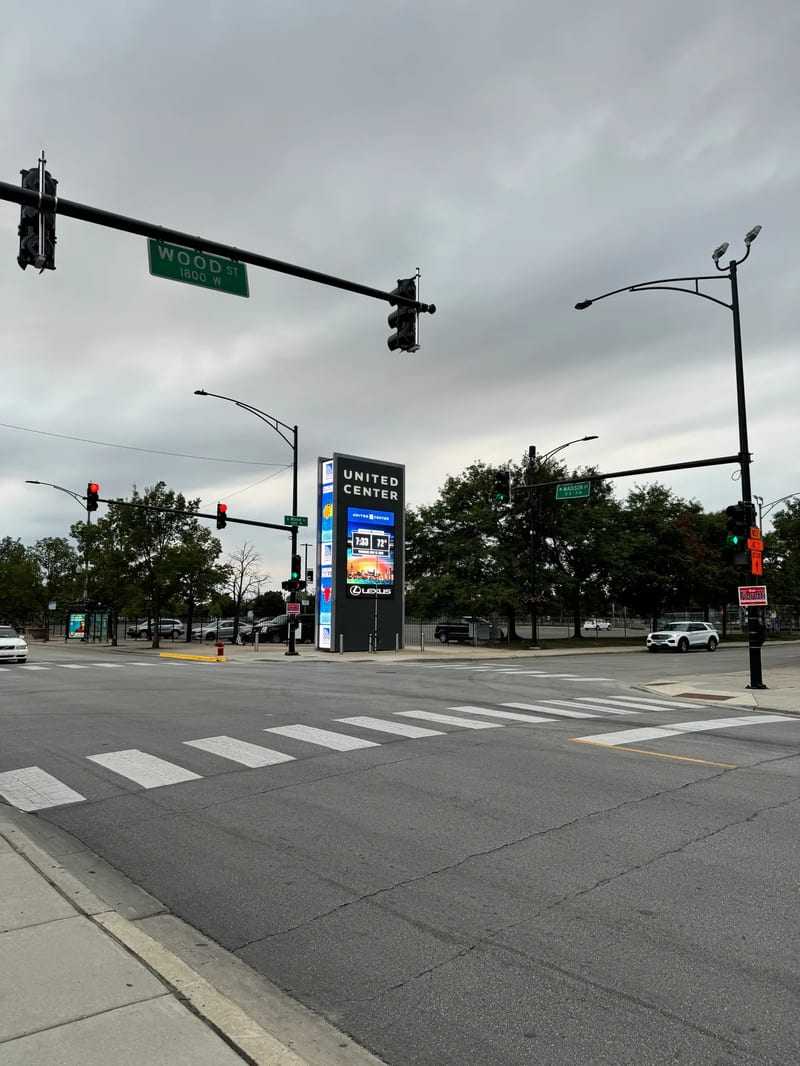Street intersection with United Center digital sign at Madison and Wood, Chicago, Illinois